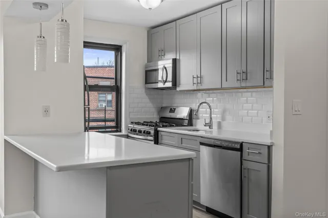 a kitchen with stainless steel appliances granite countertop a sink stove and cabinets
