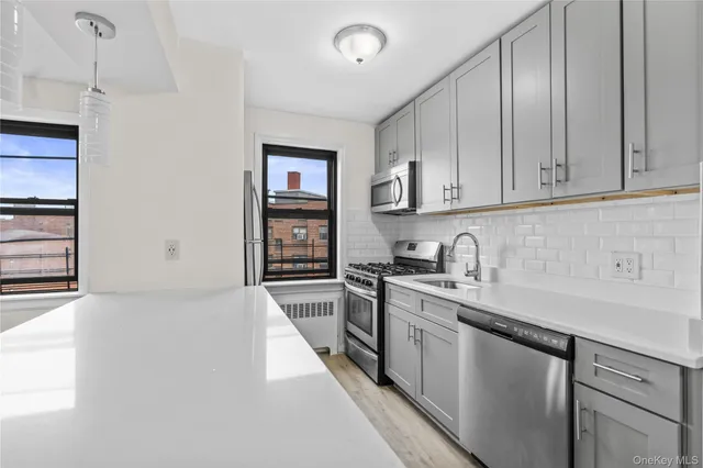 a kitchen with stainless steel appliances granite countertop a sink stove and cabinets