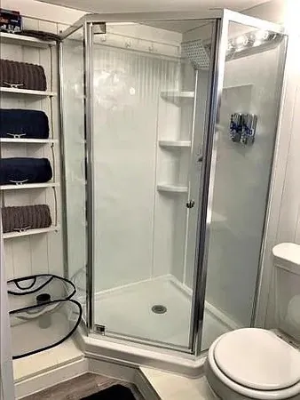 a bathroom with a shower a toilet and a sink