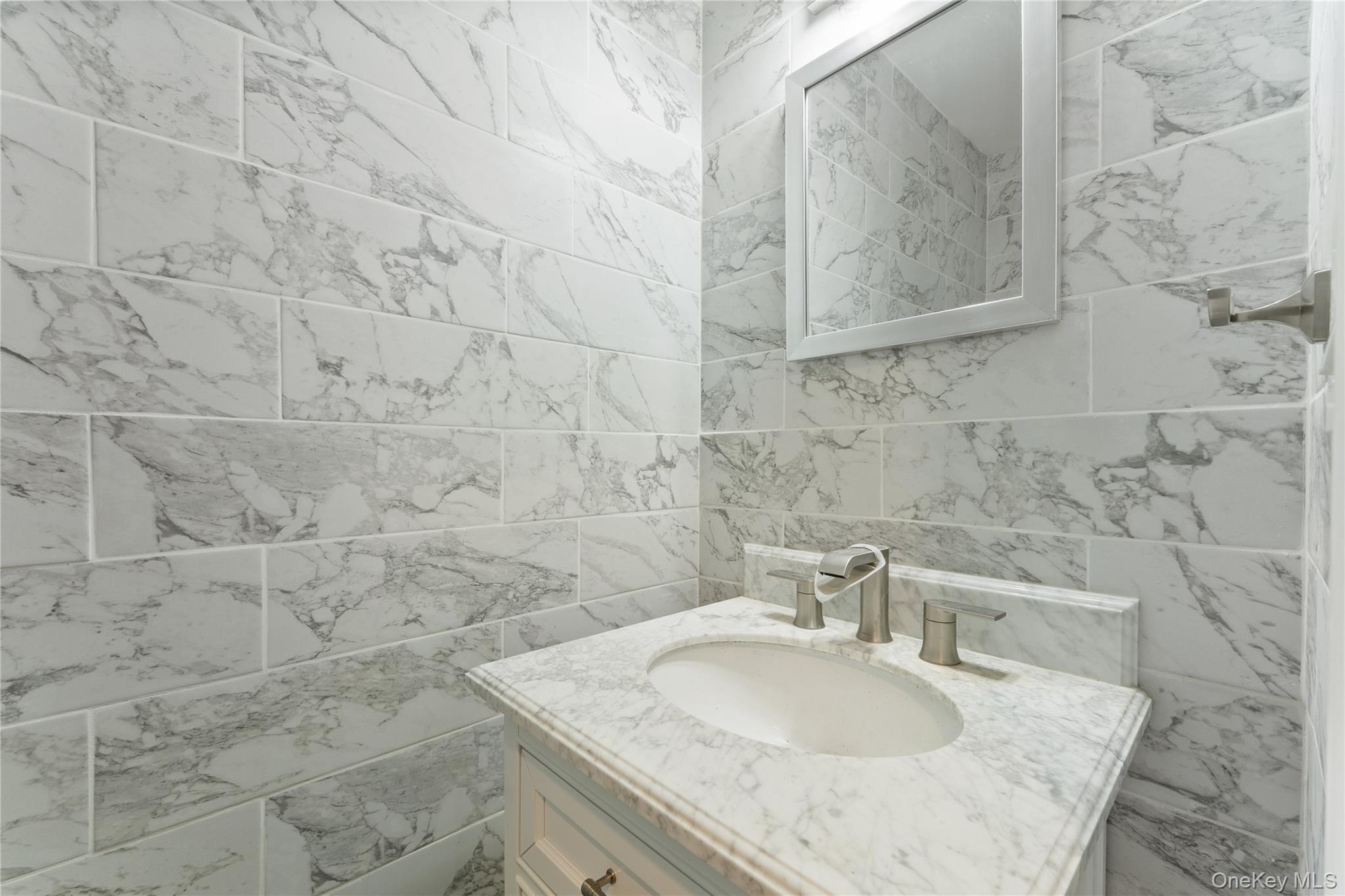 147 I U Willets Road Albertson, NY 11507 - Photo 7 of 14 a bathroom with a granite countertop sink and a mirror