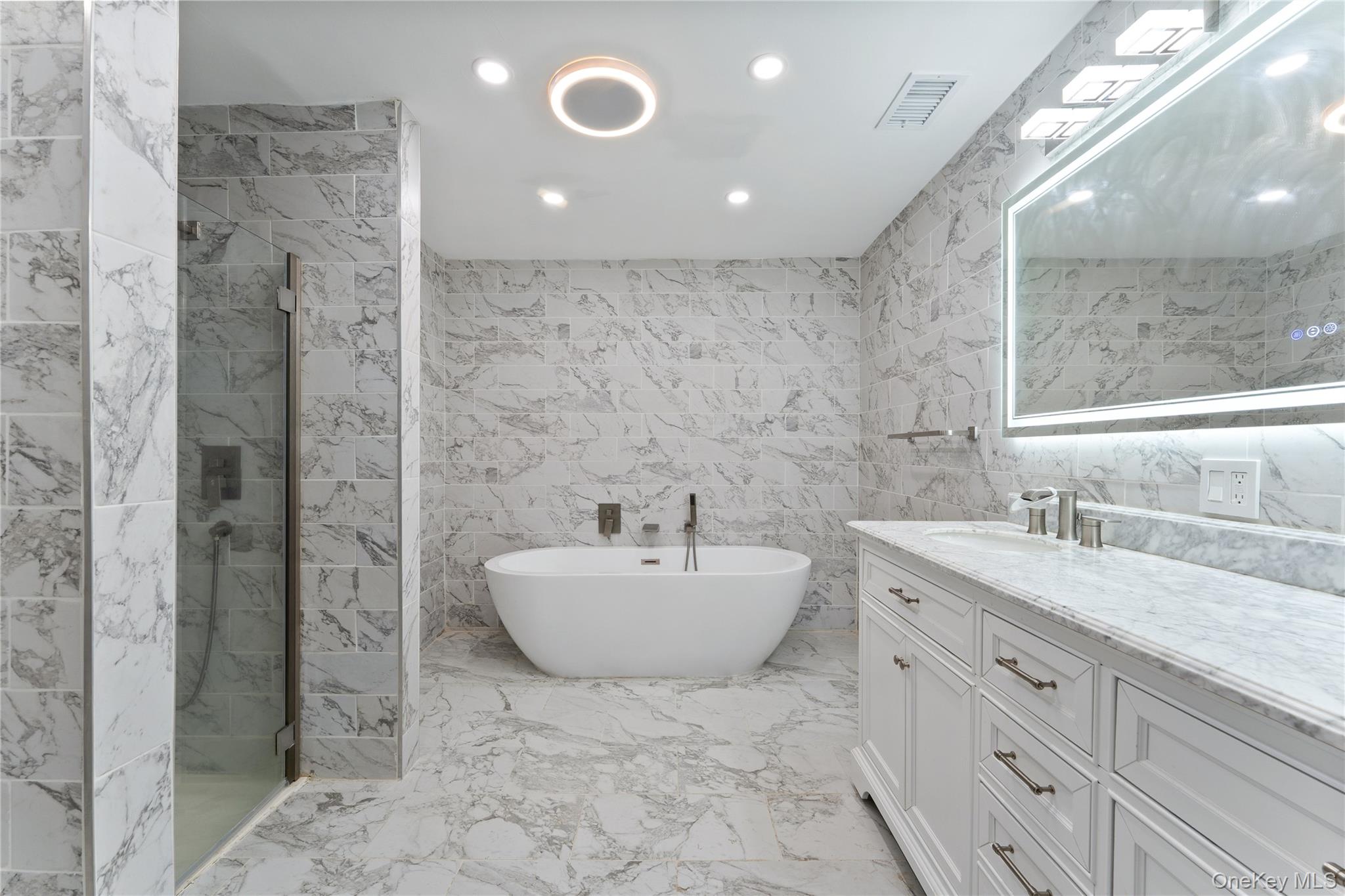 147 I U Willets Road Albertson, NY 11507 - Photo 10 of 14 a bathroom with a sink and a mirror