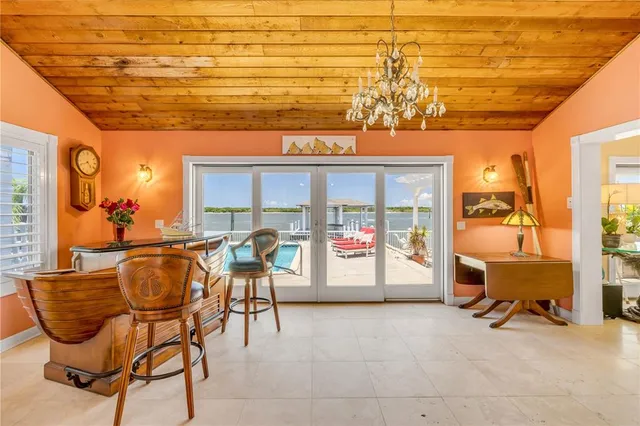 a view of a big room with chandelier fan and windows