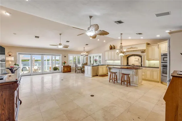 a spacious bedroom with furniture and large windows