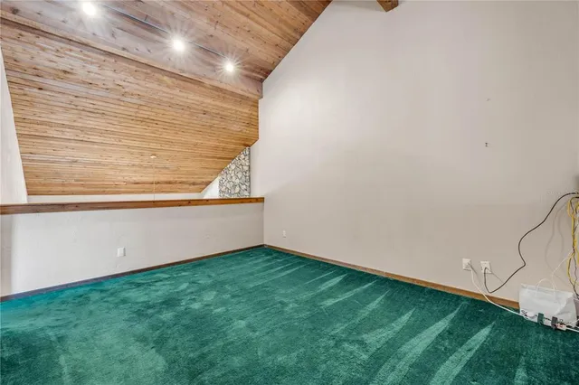 a view of an empty room with window and closet area