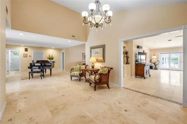 a dining room with furniture and a floor to ceiling window