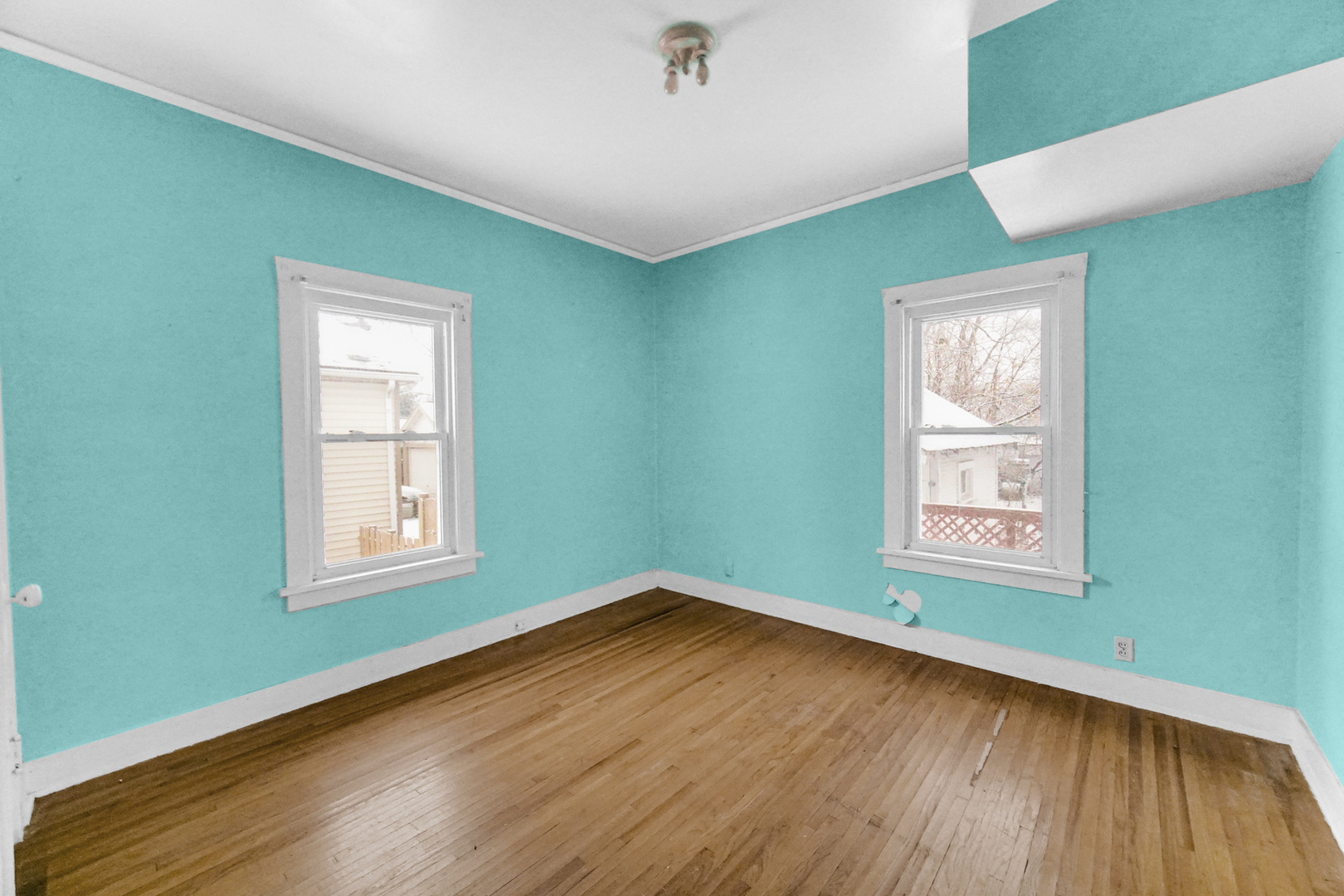 1009 Augusta Avenue Elgin, IL 60120 - Photo 11 of 24 an empty room with wooden floor and windows