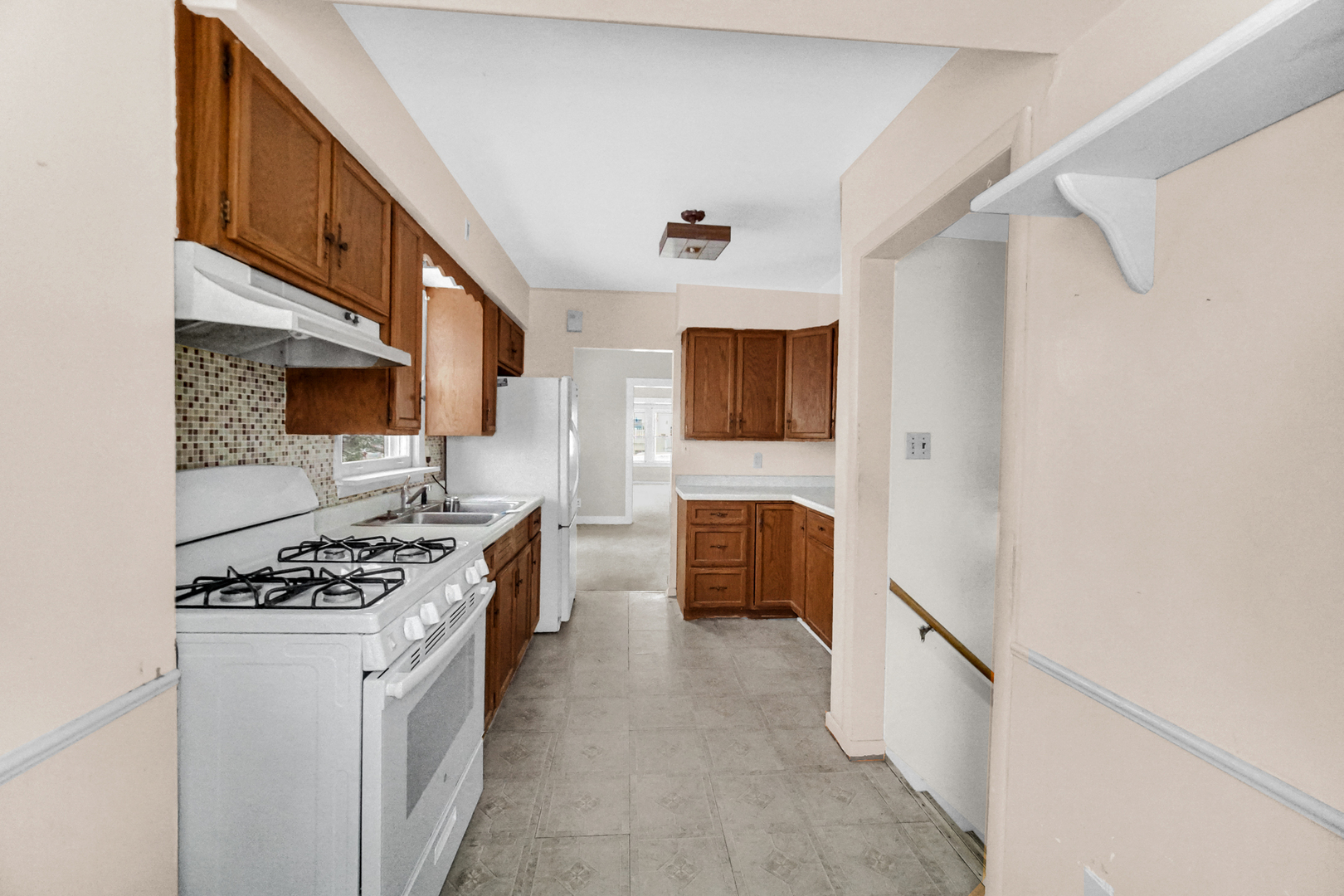 1009 Augusta Avenue Elgin, IL 60120 - Photo 14 of 24 a kitchen with stainless steel appliances a stove a microwave and a refrigerator