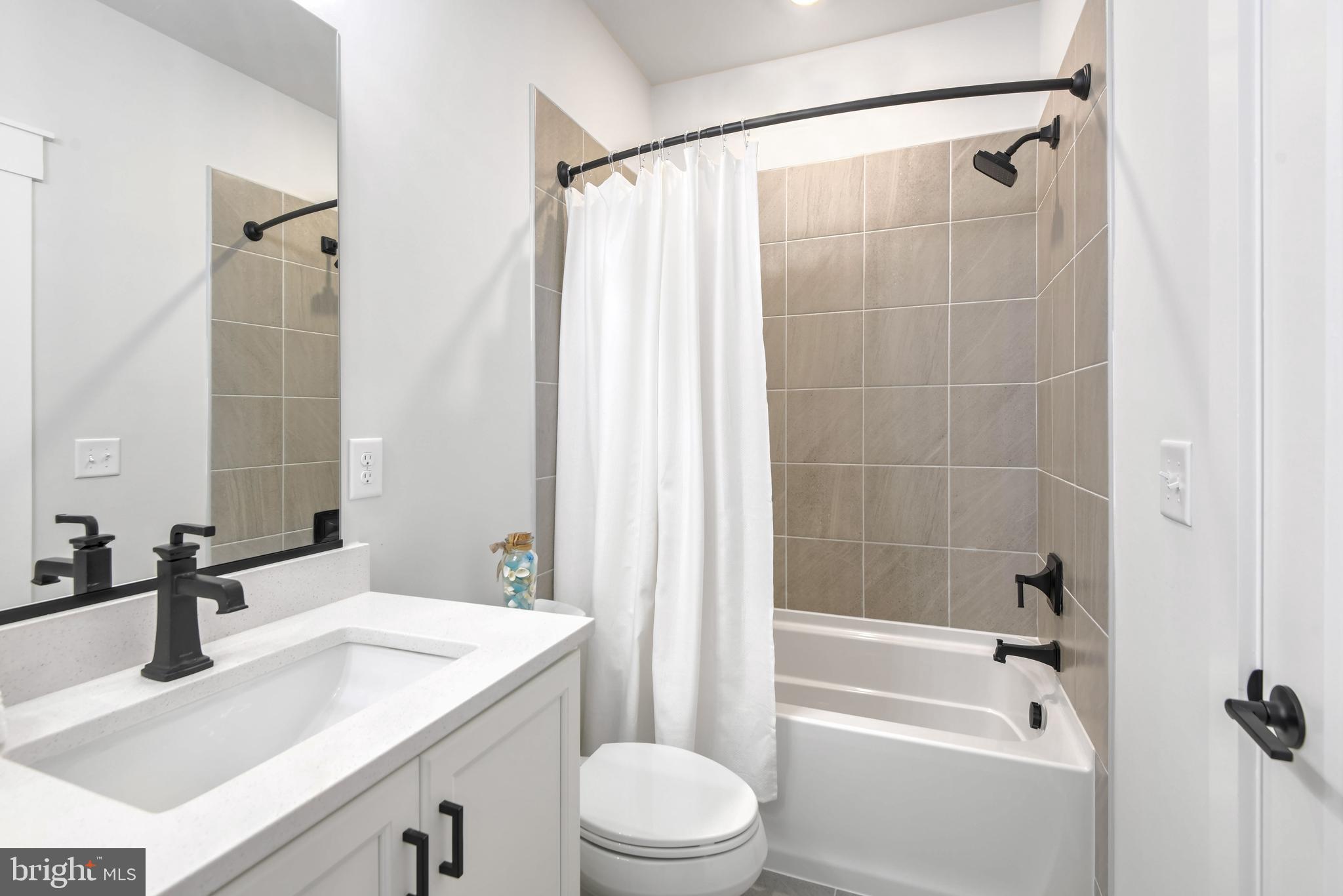 Eliana Court Laurel, MD 20708 - Photo 34 of 46 a bathroom with a sink toilet vanity and shower