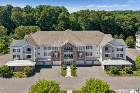 an aerial view of a house with swimming pool garden and patio