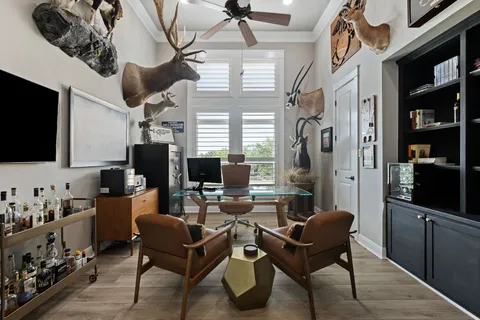 a view of a livingroom with workspace and a window