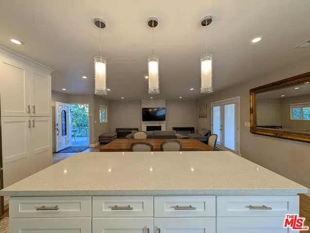 a large room with a large screen and couches