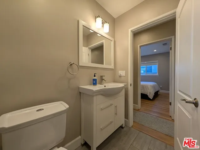 a en suite bathroom with a toilet sink and mirror