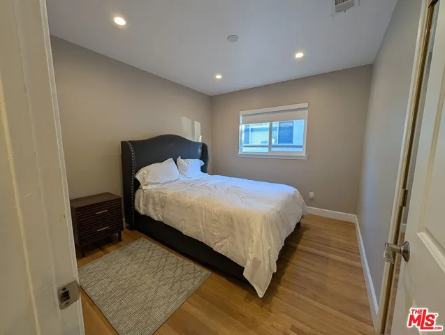 a bedroom with a bed and a night stand
