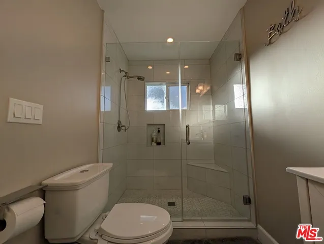 a bathroom with a toilet and a shower