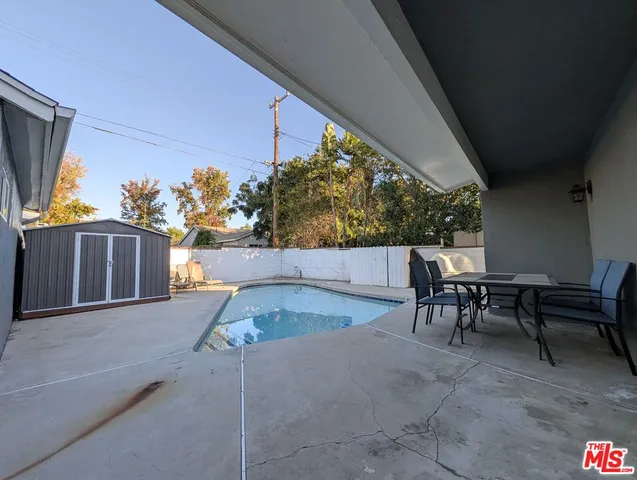 a view of outdoor kitchen outdoor dining space and furniture
