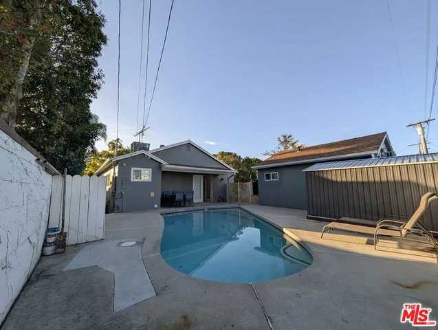 a view of a house with a small yard and wooden fence