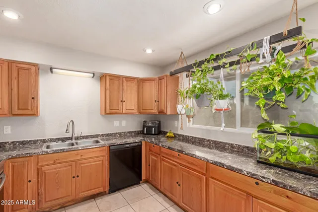 a kitchen with granite countertop lots of counter top space and windows