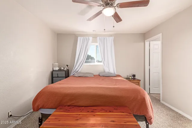 a bedroom with a bed and window