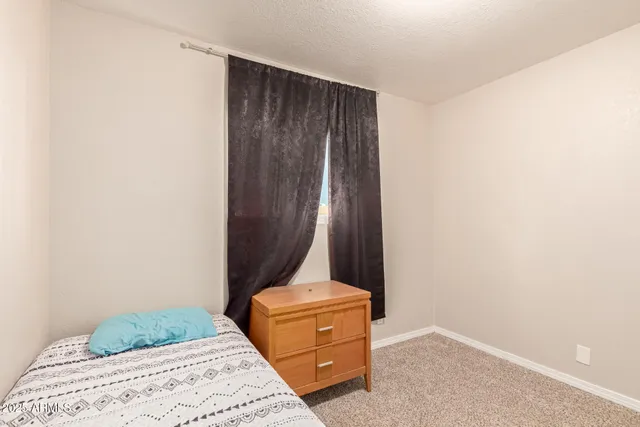 a bedroom with a bed and a yard