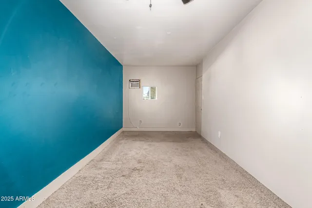 an empty room with a empty space and windows