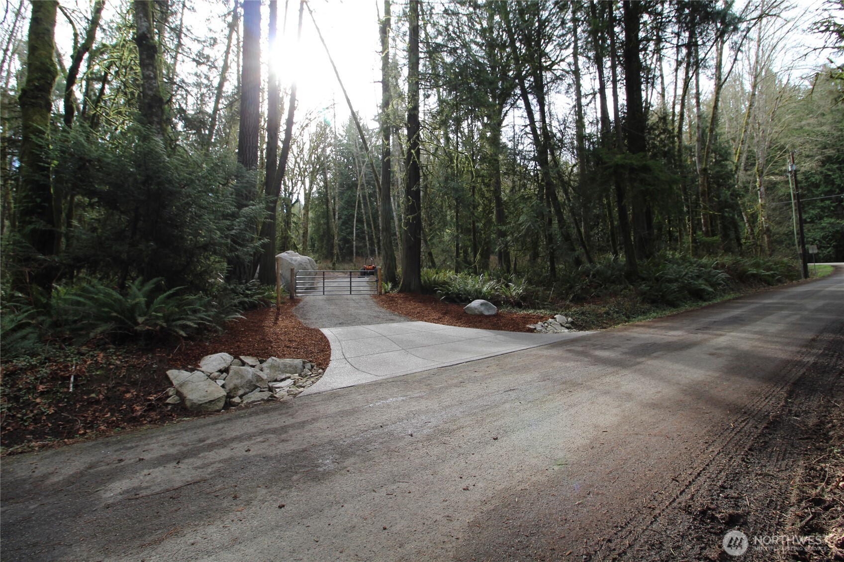 6509 Northeast Sid Price Road Poulsbo, WA 98370 - Photo 2 of 16 a view of a backyard with plants and trees
