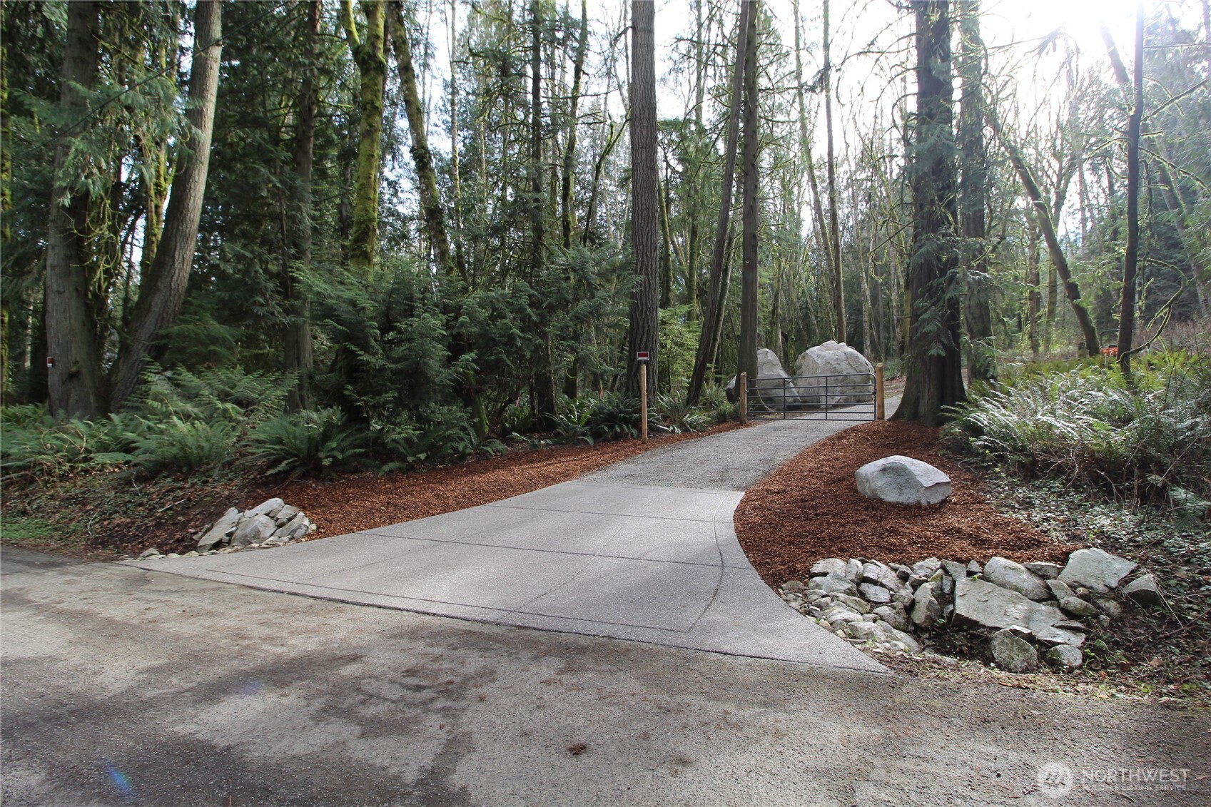 6509 Northeast Sid Price Road Poulsbo, WA 98370 - Photo 3 of 16 a backyard of a house with a yard and outdoor seating