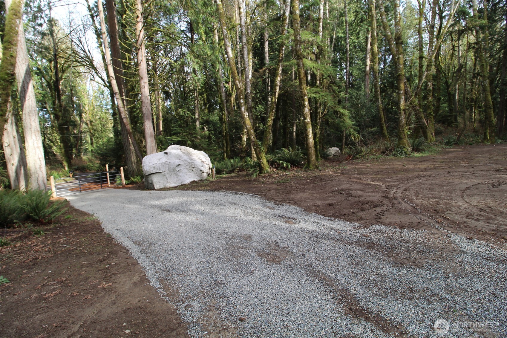 6509 Northeast Sid Price Road Poulsbo, WA 98370 - Photo 5 of 16 a view of a field with trees in the background