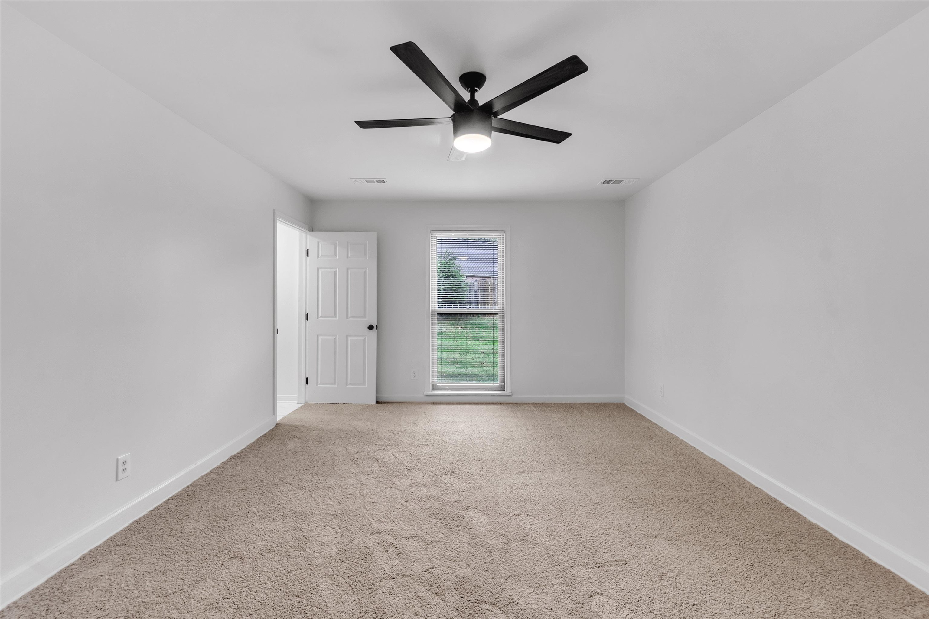 7218 Barnstable Road Memphis, TN 38125 - Photo 11 of 18 Unfurnished room with light colored carpet and a ceiling fan