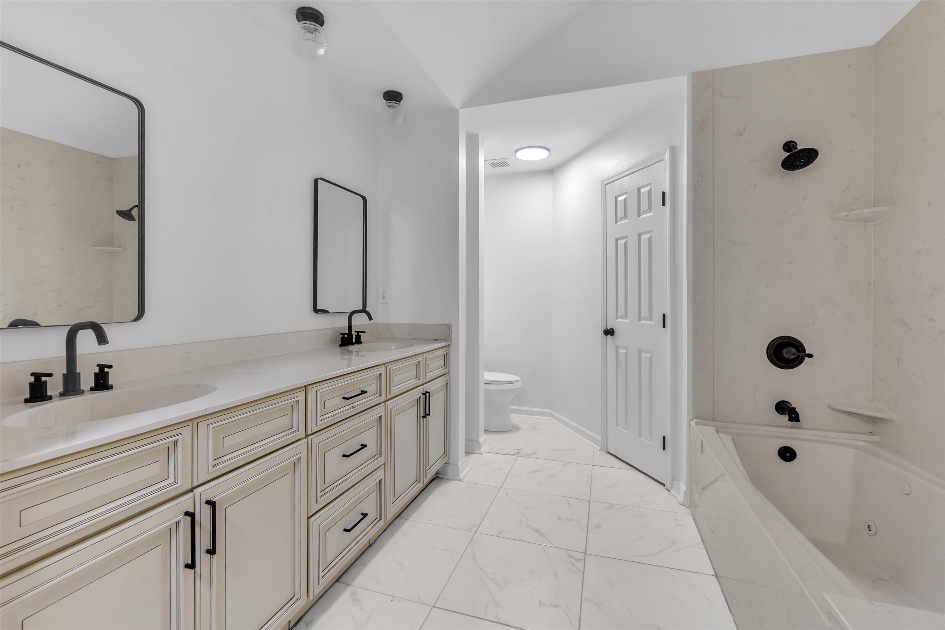 7218 Barnstable Road Memphis, TN 38125 - Photo 12 of 18 Full bath with double vanity, light marble finish floors, and shower combination