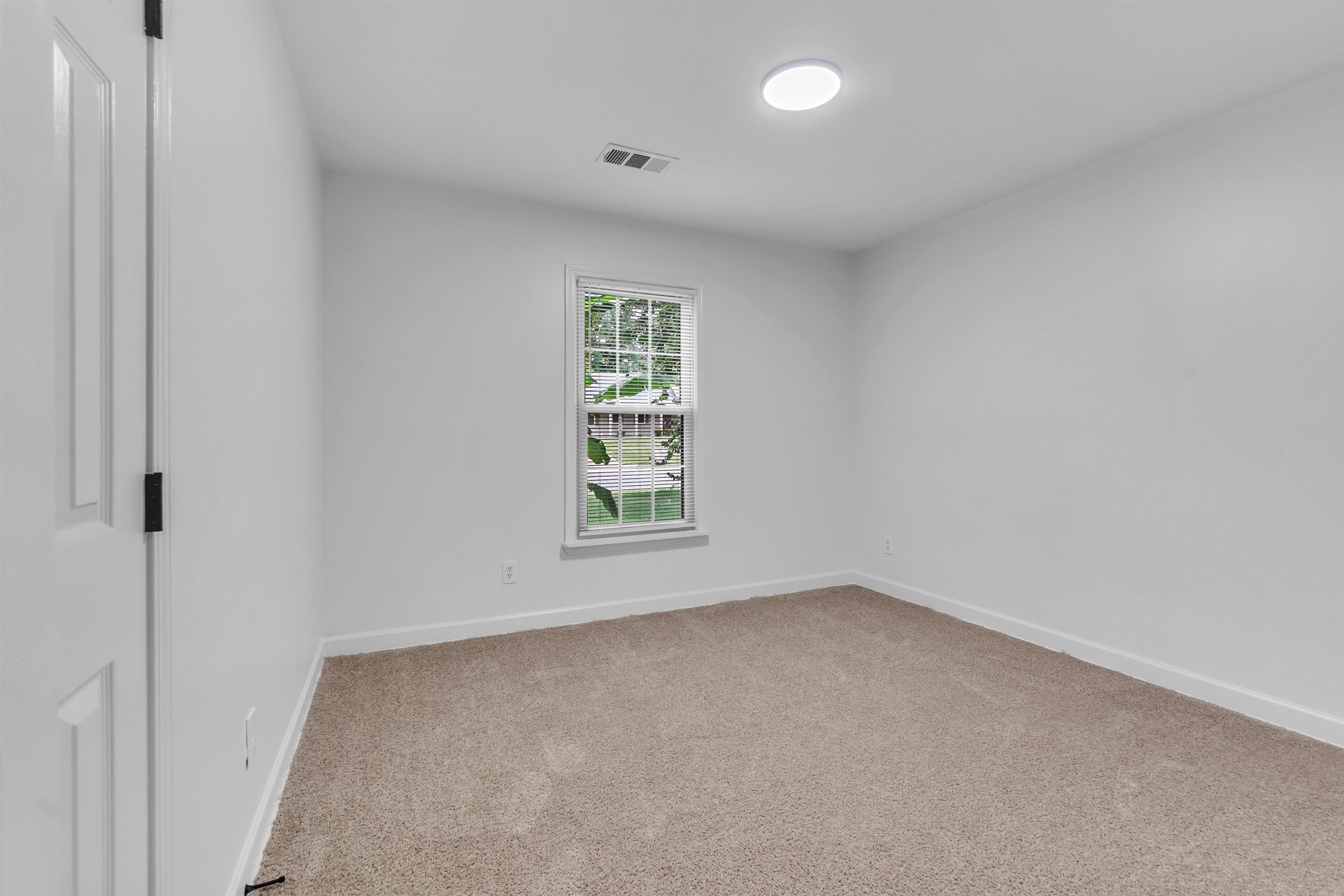 7218 Barnstable Road Memphis, TN 38125 - Photo 15 of 18 Spare room featuring light colored carpet and baseboards