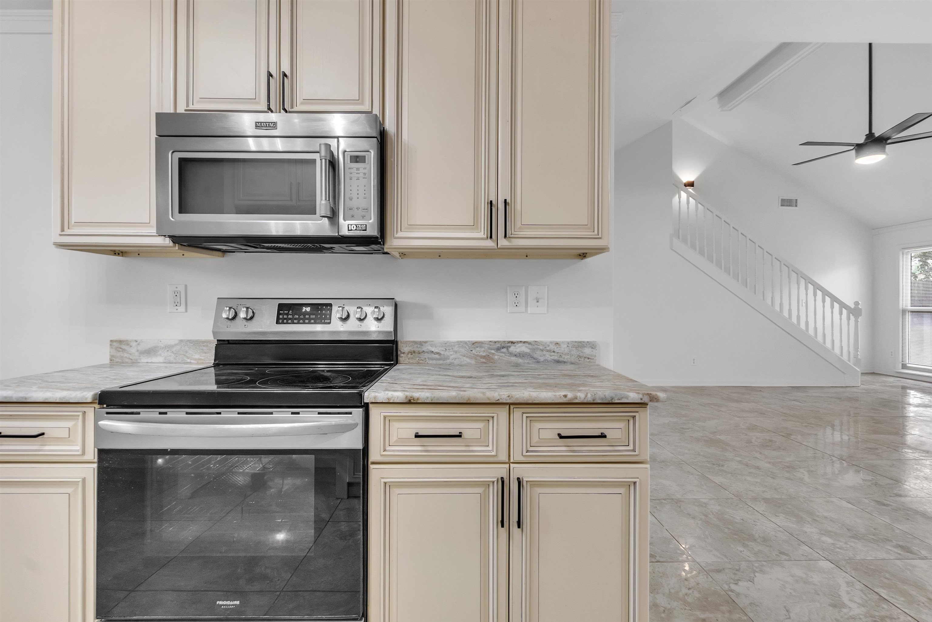 7218 Barnstable Road Memphis, TN 38125 - Photo 8 of 18 Kitchen with cream cabinets, stainless steel appliances, light countertops, ceiling fan, and lofted ceiling