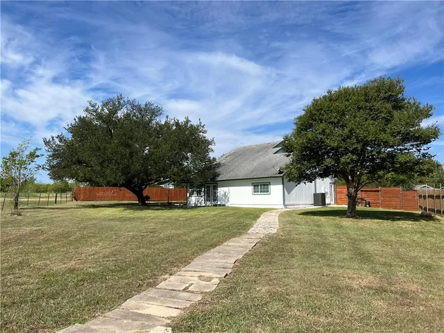 a view of a field of grass and trees
