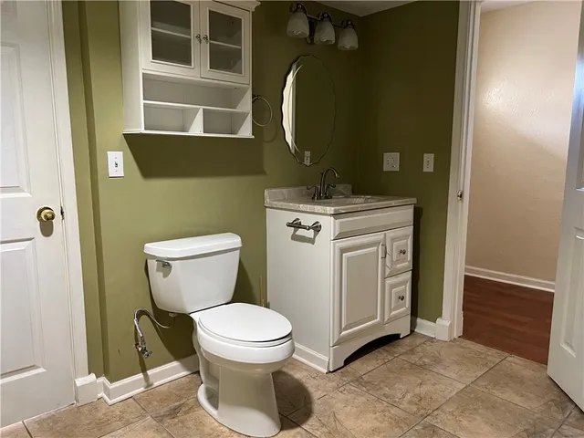 a bathroom with a toilet and a mirror