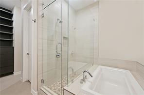 5921 Hiline Road, Unit 1203 Austin, TX 78734 - Photo 22 of 34 A glass-enclosed shower next to a deep soaking tub provides a spa-like retreat.