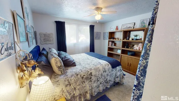 a bedroom with a bed furniture and a window