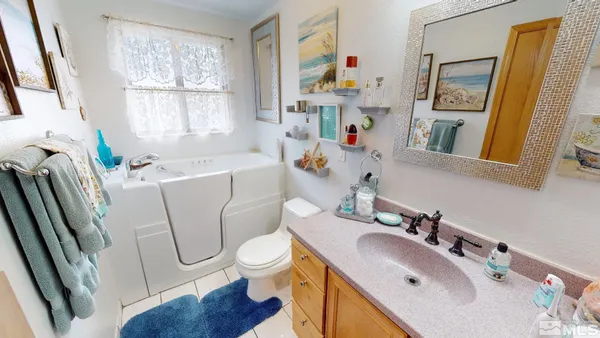 a white toilet sitting next to a bathroom sink