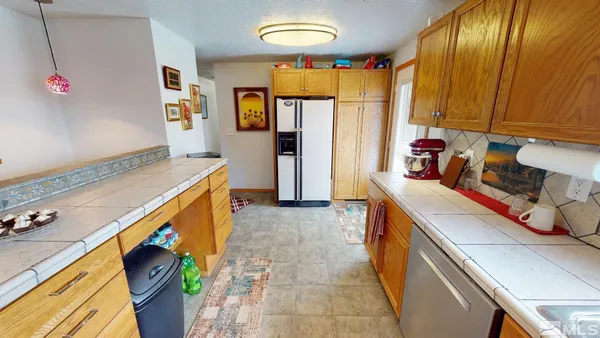a kitchen that has a sink and a stove in it