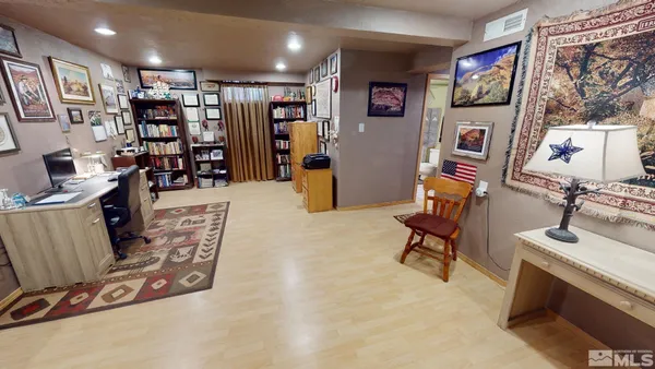 a view of a livingroom with workspace and a couch
