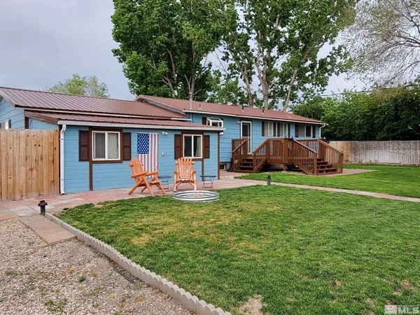 a view of a house with backyard sitting area and garden