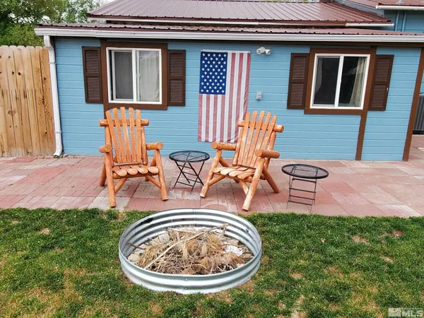 a view of a backyard with table and chairs