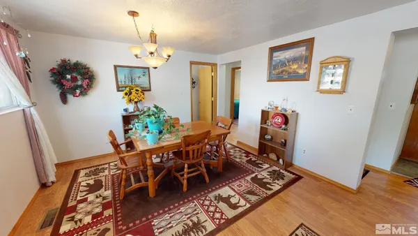 a view of a dining room with furniture and a chandelier