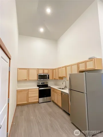 a kitchen with a sink and white stainless steel appliances