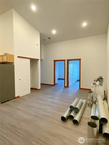 a room with wooden floor and gym equipment