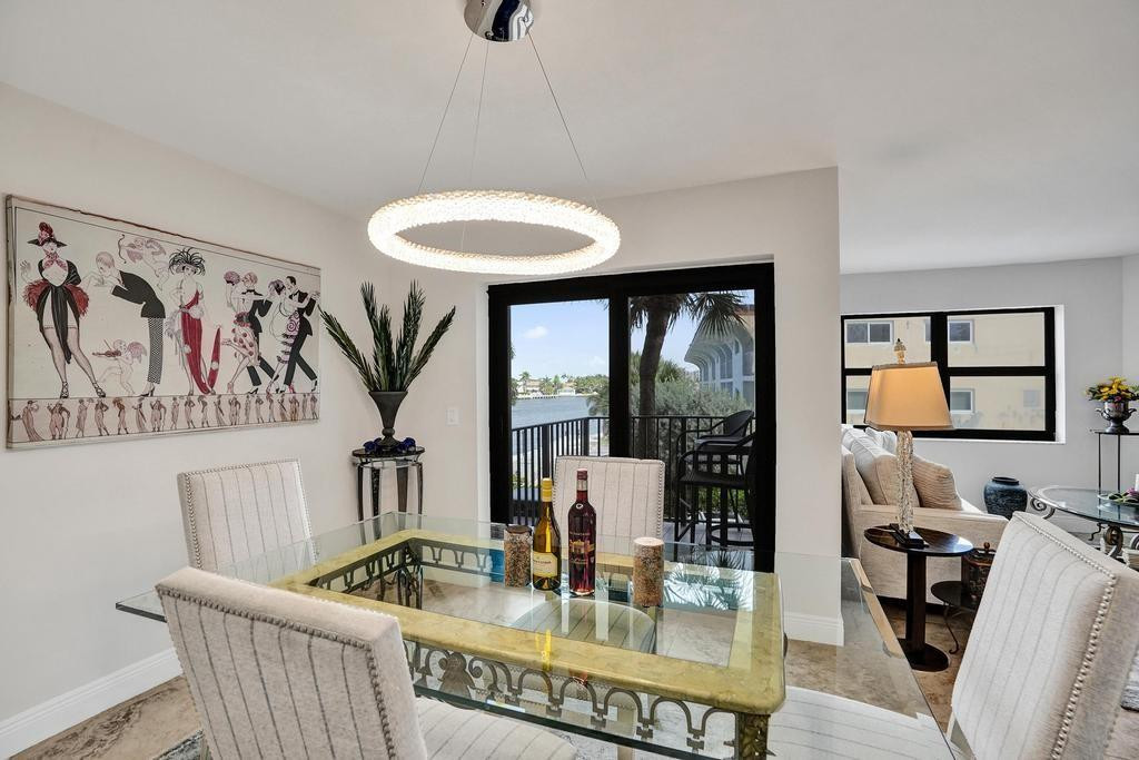 501 North Riverside Drive, Unit 203 Pompano Beach, FL 33062 - Photo 20 of 63 a dining room with furniture and a floor to ceiling window