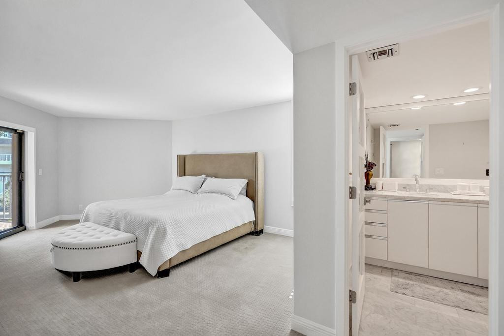 501 North Riverside Drive, Unit 203 Pompano Beach, FL 33062 - Photo 27 of 63 a bedroom with a bed and view of living room