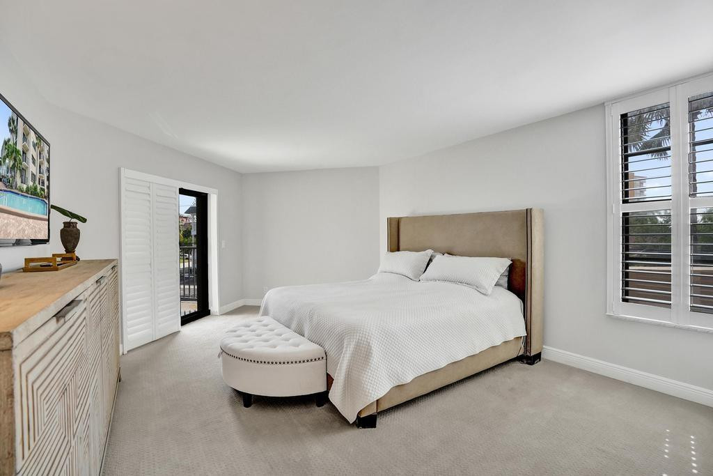 501 North Riverside Drive, Unit 203 Pompano Beach, FL 33062 - Photo 28 of 63 a spacious bedroom with a bed and a cabinets