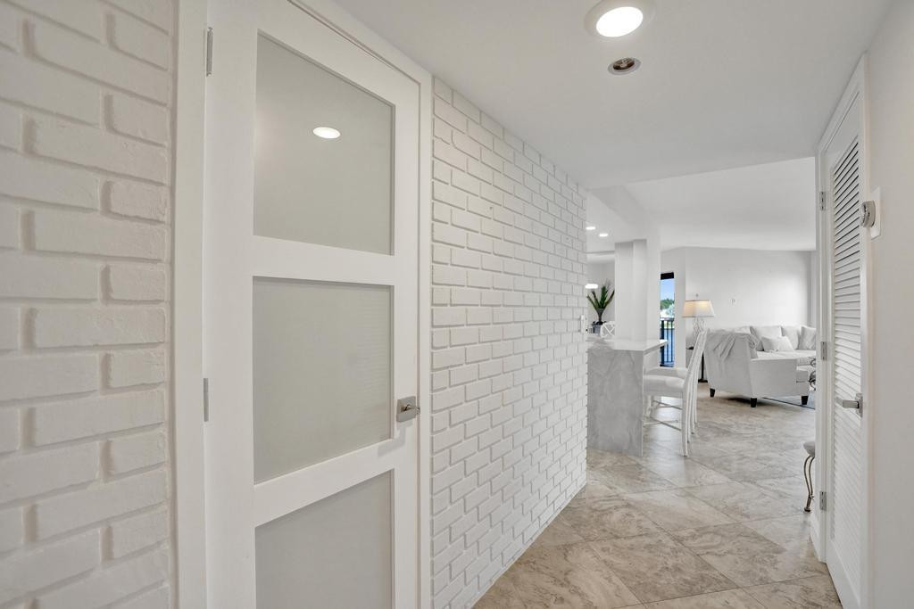 501 North Riverside Drive, Unit 203 Pompano Beach, FL 33062 - Photo 41 of 63 a view of a hallway with two couch and a view of bathroom