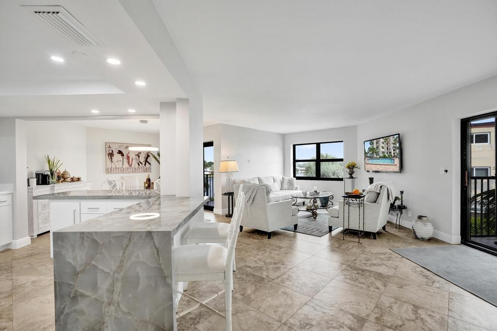 501 North Riverside Drive, Unit 203 Pompano Beach, FL 33062 - Photo 6 of 63 a living room with furniture and white walls