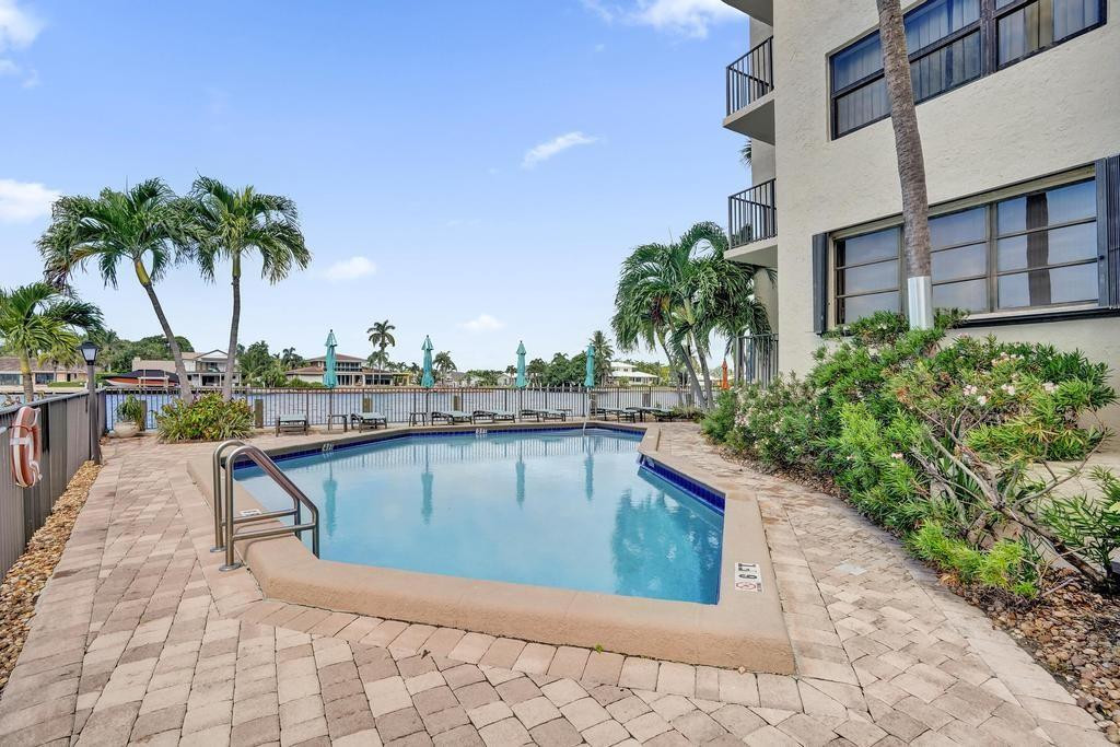 501 North Riverside Drive, Unit 203 Pompano Beach, FL 33062 - Photo 61 of 63 a view of swimming pool with outdoor seating and plants