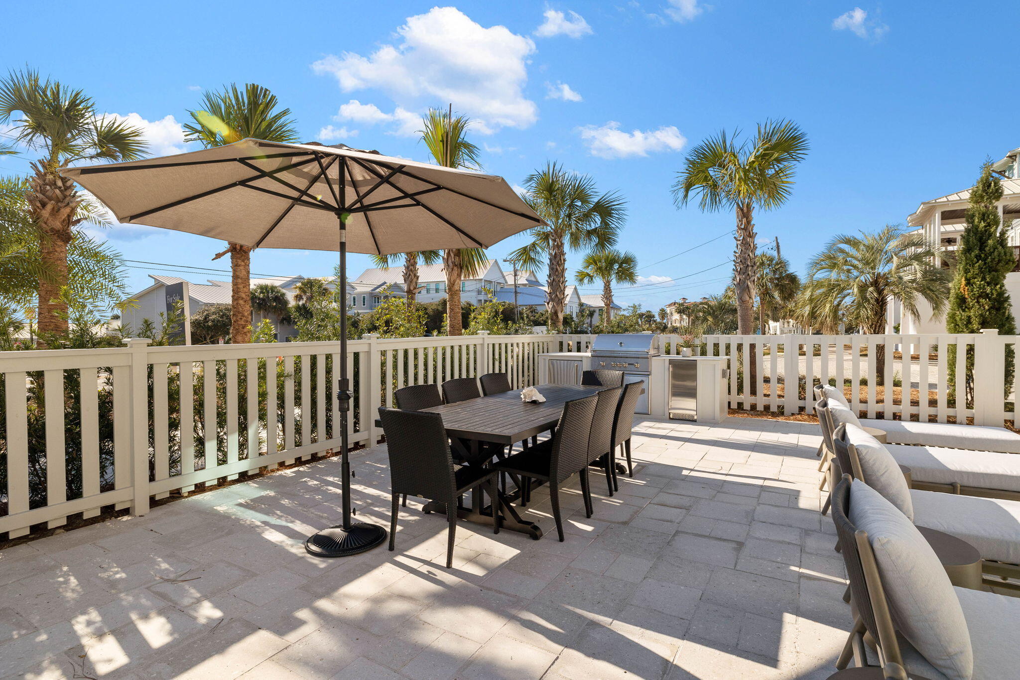 8069 East County Highway 30A Inlet Beach, FL 32461 - Photo 113 of 119 a view of a roof deck with table and chairs under an umbrella